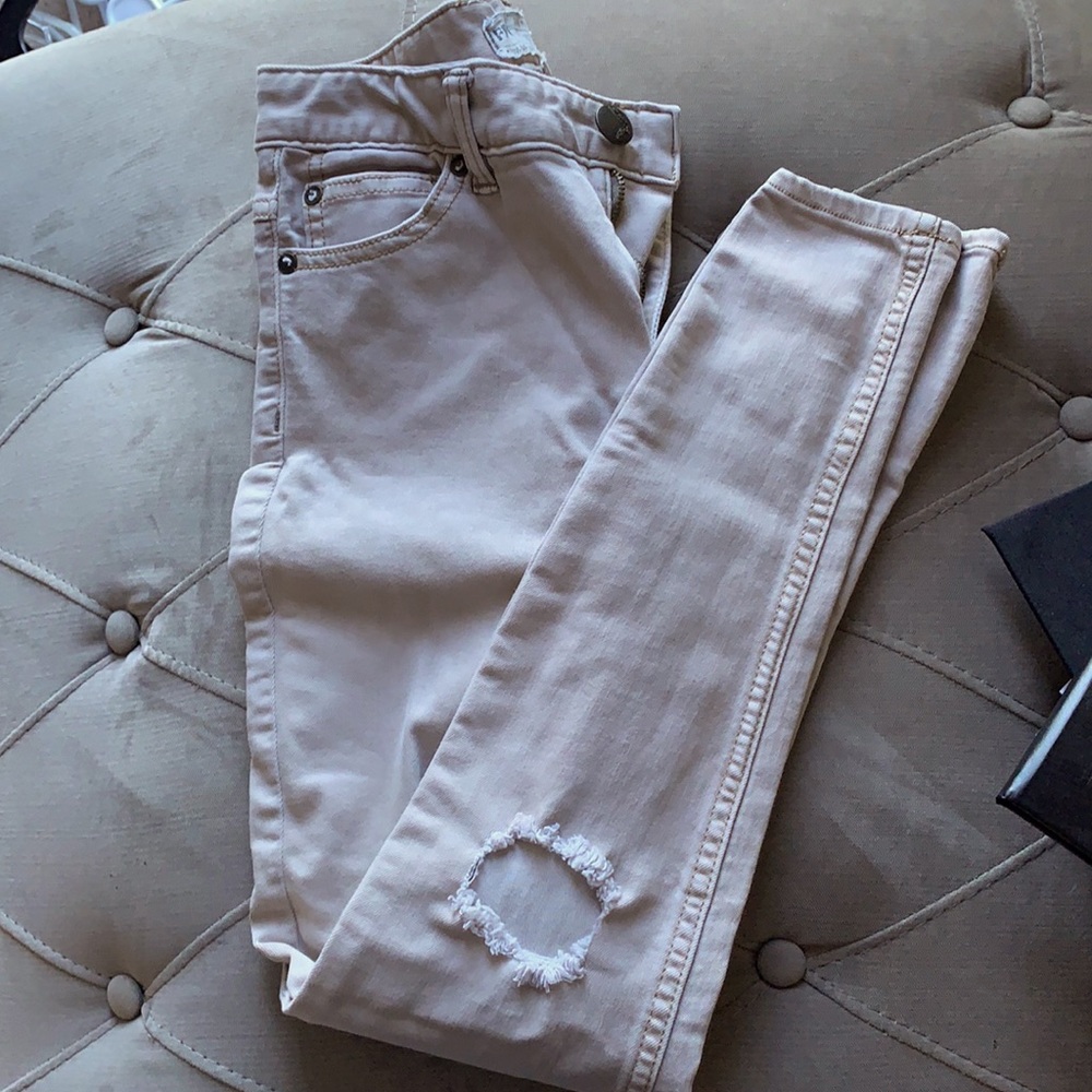 Ripped cream jeans